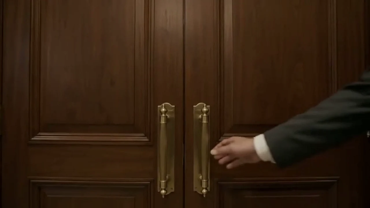 Polished wooden doors with brass handles, slightly ajar